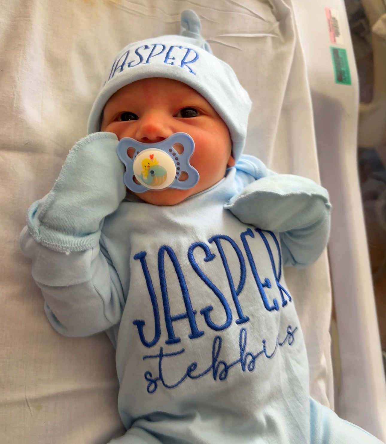 Jasper joined the competition — help win amazing prizes! baby, pacifier, hat, mittens, onesie, blue_clothing, infant, lying_down, blanket, face, cute, newborn, person, sleepwear, soft, bed, portrait, indoors, child, baby_boy