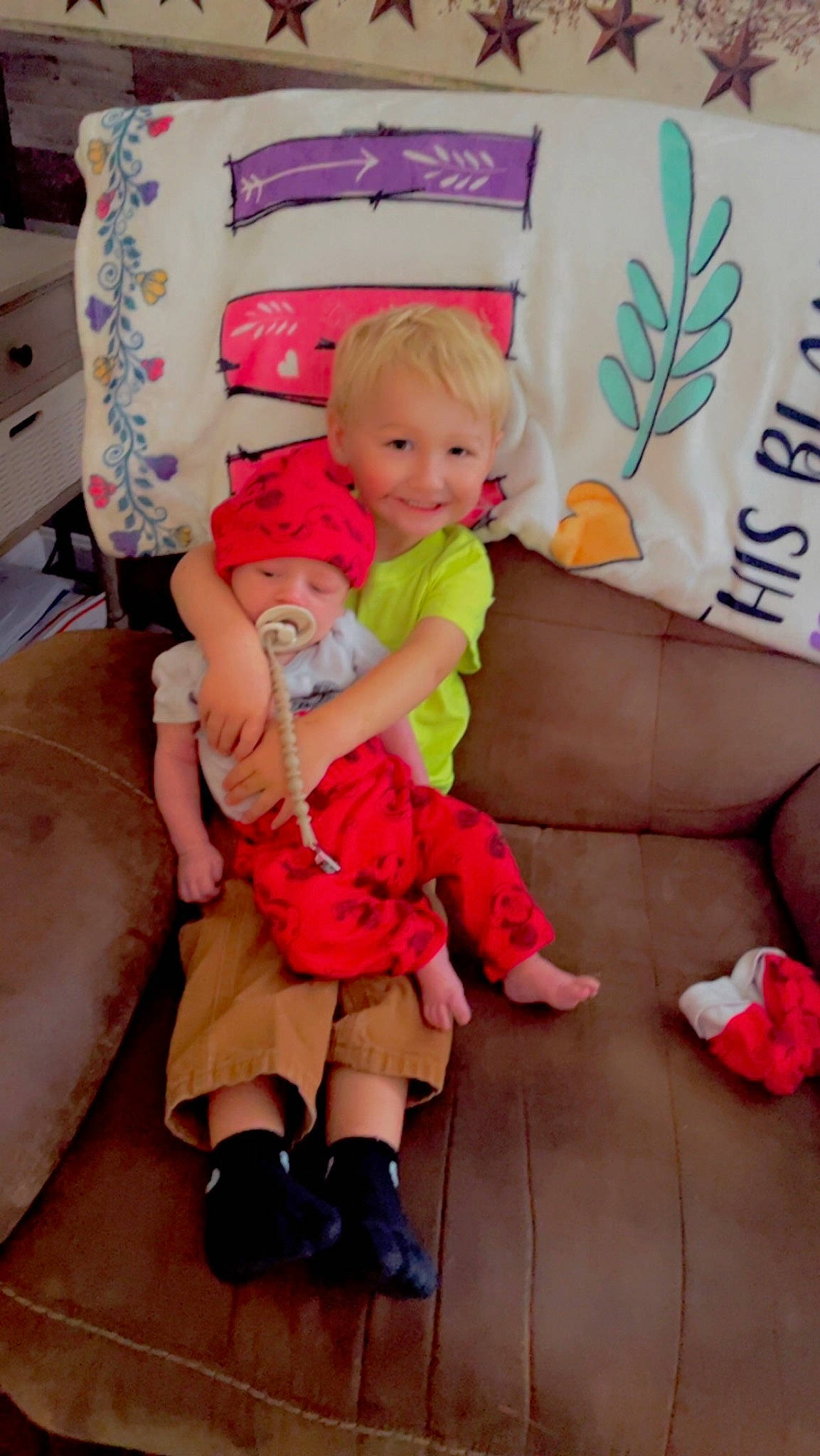 Waylon is registered to the contest to win money with this photo: baby, baby_toddler_clothing, child, comfort, couch, event, fun, happy, headwear, human_leg, joy, lap, magenta, person, pillow, pink, product, skin, smile, sock