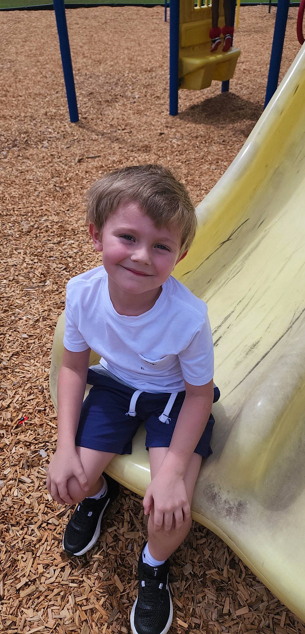 Buckley is registered to the contest to win money with this photo: baby_toddler_clothing, child, foot, fun, grass, happy, joy, leisure, people_in_nature, person, play, playground, sand, shorts, sitting, sleeve, smile, soil, t_shirt, toddler