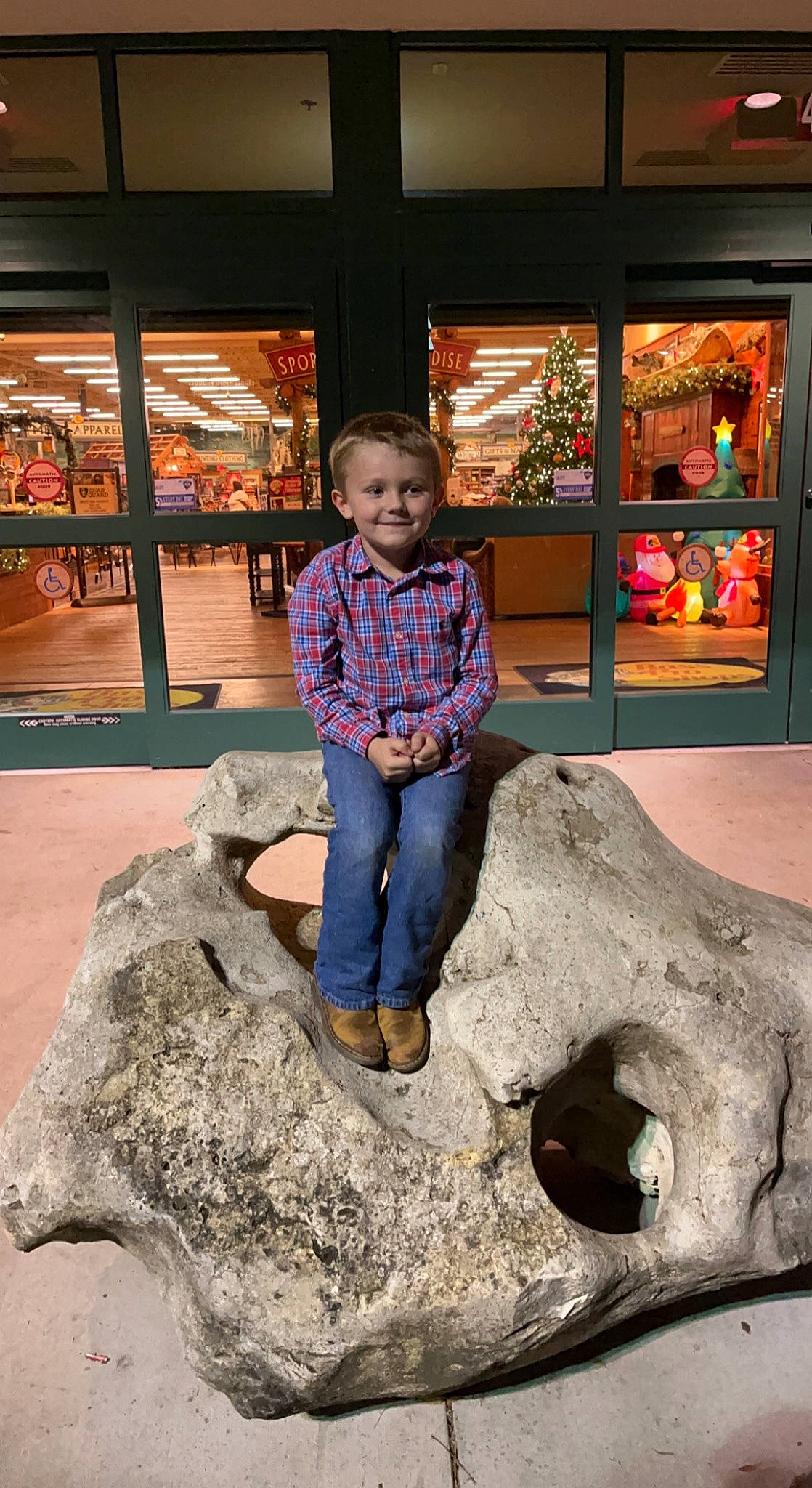 Buckley is registered to the contest to win money with this photo: bedrock, foot, fun, happy, human, jeans, joy, leaf, leisure, mammal, person, plant, sitting, smile, temple, toddler, travel, tree, trunk, vertebrate