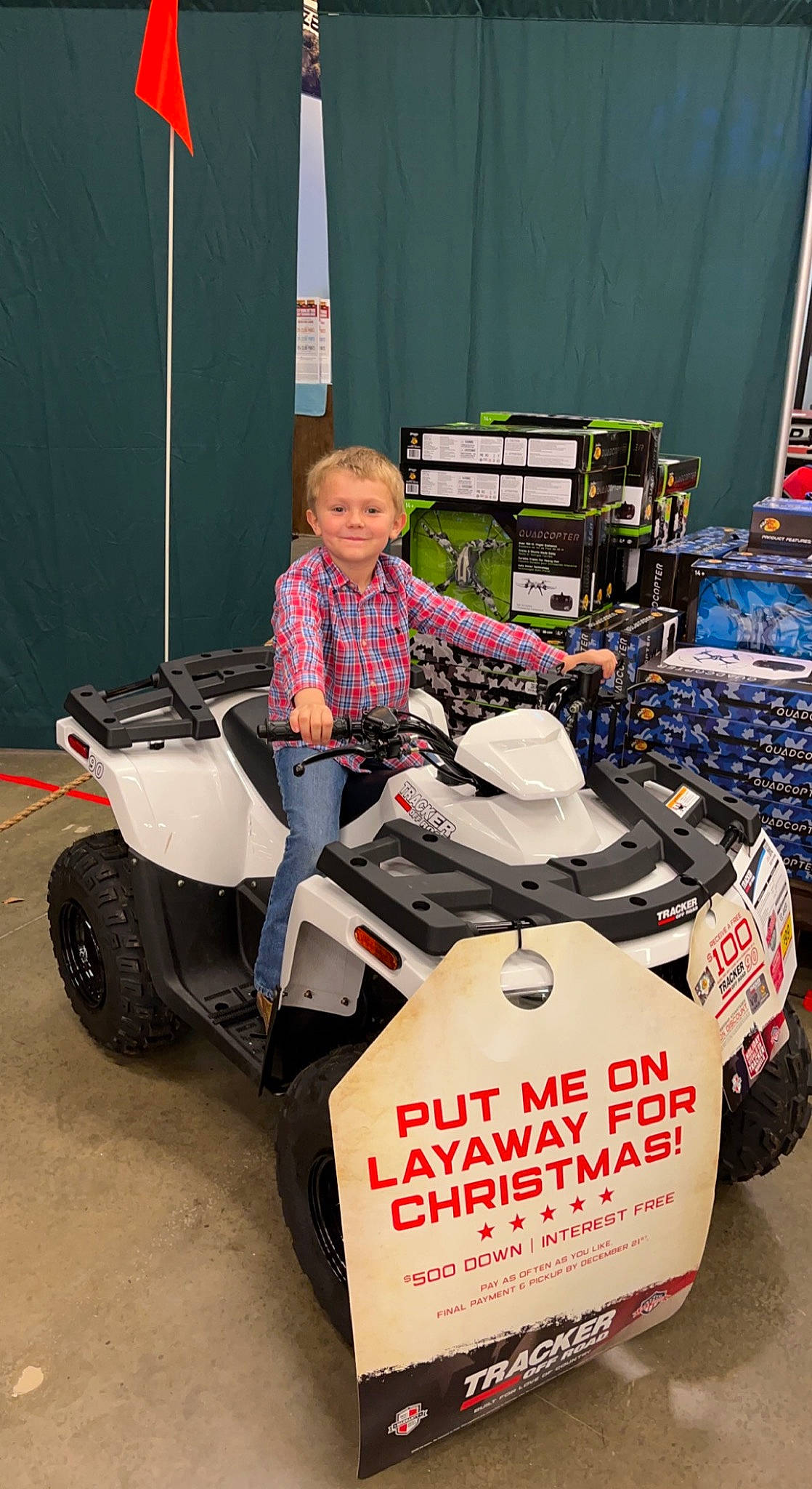 Buckley is registered to the contest to win money with this photo: auto_part, automotive_design, automotive_exterior, automotive_tire, automotive_wheel_system, bumper, fender, joy, motor_vehicle, motorsport, person, product, race_car, racing, riding_toy, rim, smile, tire, toddler, tread