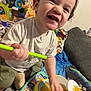 Zayden is registered to the contest to win money with this photo: toddler, child, toy, drum, drumstick, smile, happy, indoor, blanket, cushion, clothing, person, play, fun, music, baby, home, cute, sitting, colorful