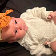Kinsley is registered to the contest to win money with this photo: baby, infant, headband, bow, white_clothing, knitted, cute, face, skin, hands, legs, lying_down, soft_lighting, closeup, portrait, child, newborn, apparel, indoor, adorable