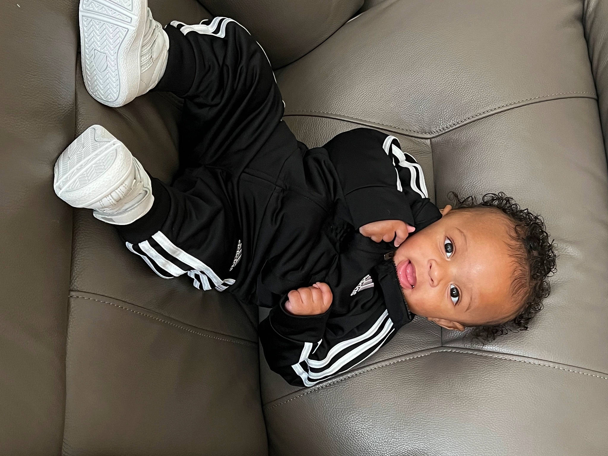 Dior is registered to the contest to win money with this photo: auto_part, baby, baby_products, baby_toddler_clothing, child, comfort, elbow, fashion_accessory, flash_photography, font, gesture, knee, person, room, sitting, sleeve, t_shirt, thigh, toddler