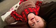 Lilith joined the competition — help win amazing prizes! blanket, carpet, child, comfort, cozy, cute, face, happy, head, home, indoor, lying_down, pajamas, person, plaid, smiling, soft_focus, toddler, warm, young_child