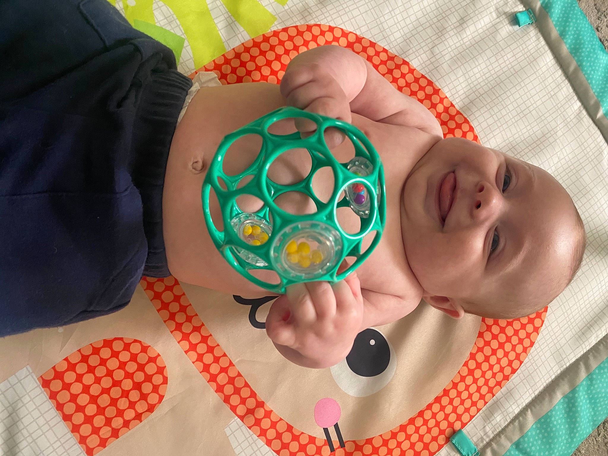 Boston is registered to the contest to win money with this photo: baby, baby_products, baby_toddler_clothing, child, circle, comfort, easter_egg, fashion_accessory, finger, foot, joy, linens, musical_instrument, nail, pattern, person, personal_protective_equipment, play, sandal, textile
