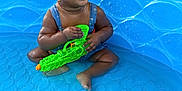 Emmery joined the competition — help win amazing prizes! blue, child, clothing, cute, feet, fun, happy, indoor, infant, legs, people, play, pool, sitting, smiling, summer, toddler, toy, water, water_gun