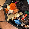 Darcy is registered to the contest to win money with this photo: puppy, sleeping, stuffed_toy, blanket, playpen, dog_bowl, toy_rope, plush_toy, brown_dog, cozy, pet, indoor, resting, cute, animal, soft, furry, comfort, nap, relaxation