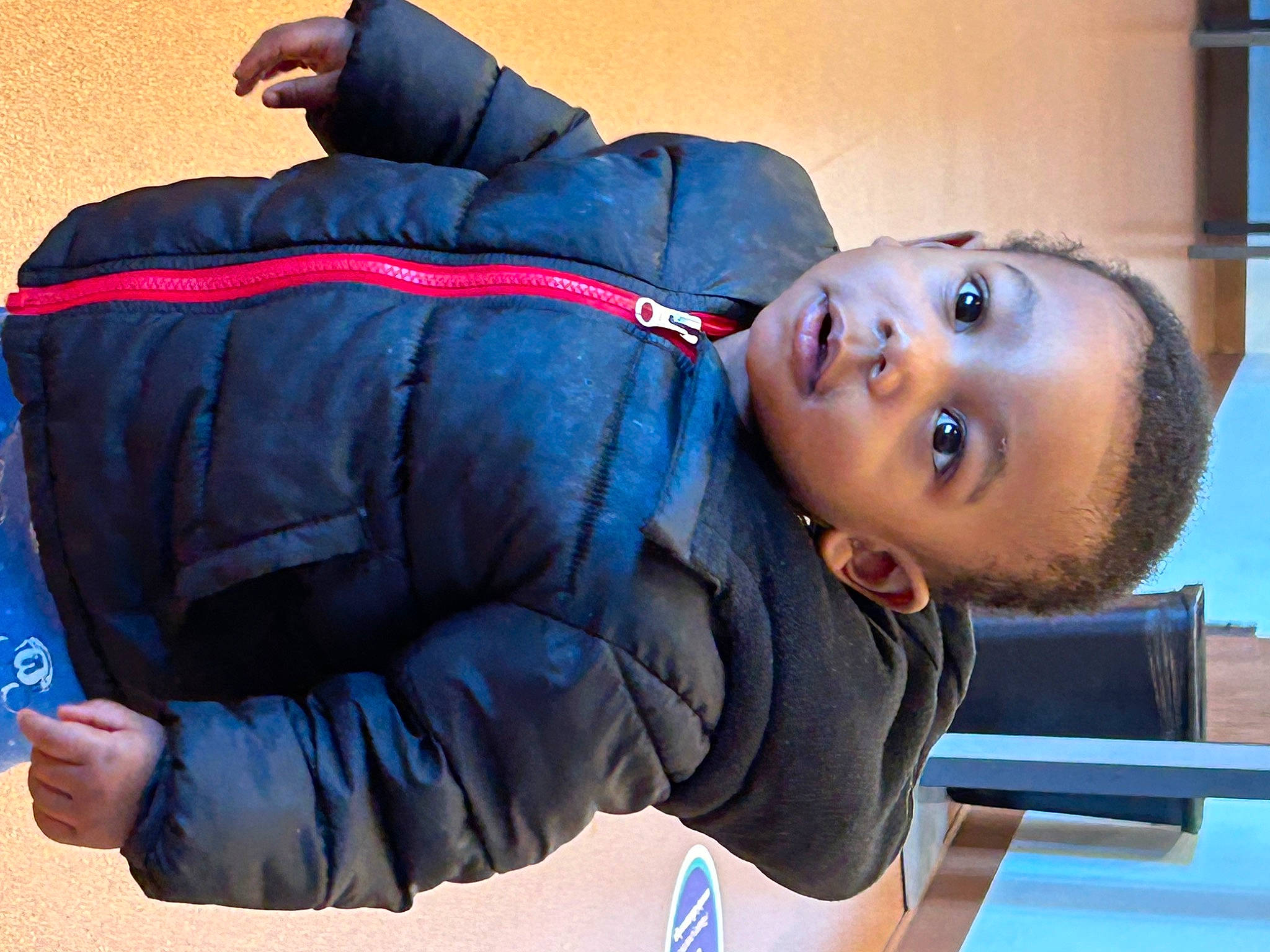 Jakari is registered to the contest to win money with this photo: abdomen, backpack, blue, child, comfort, cool, denim, elbow, electric_blue, fun, knee, leisure, mouth, nap, person, sitting, sleeve, sportswear, toddler