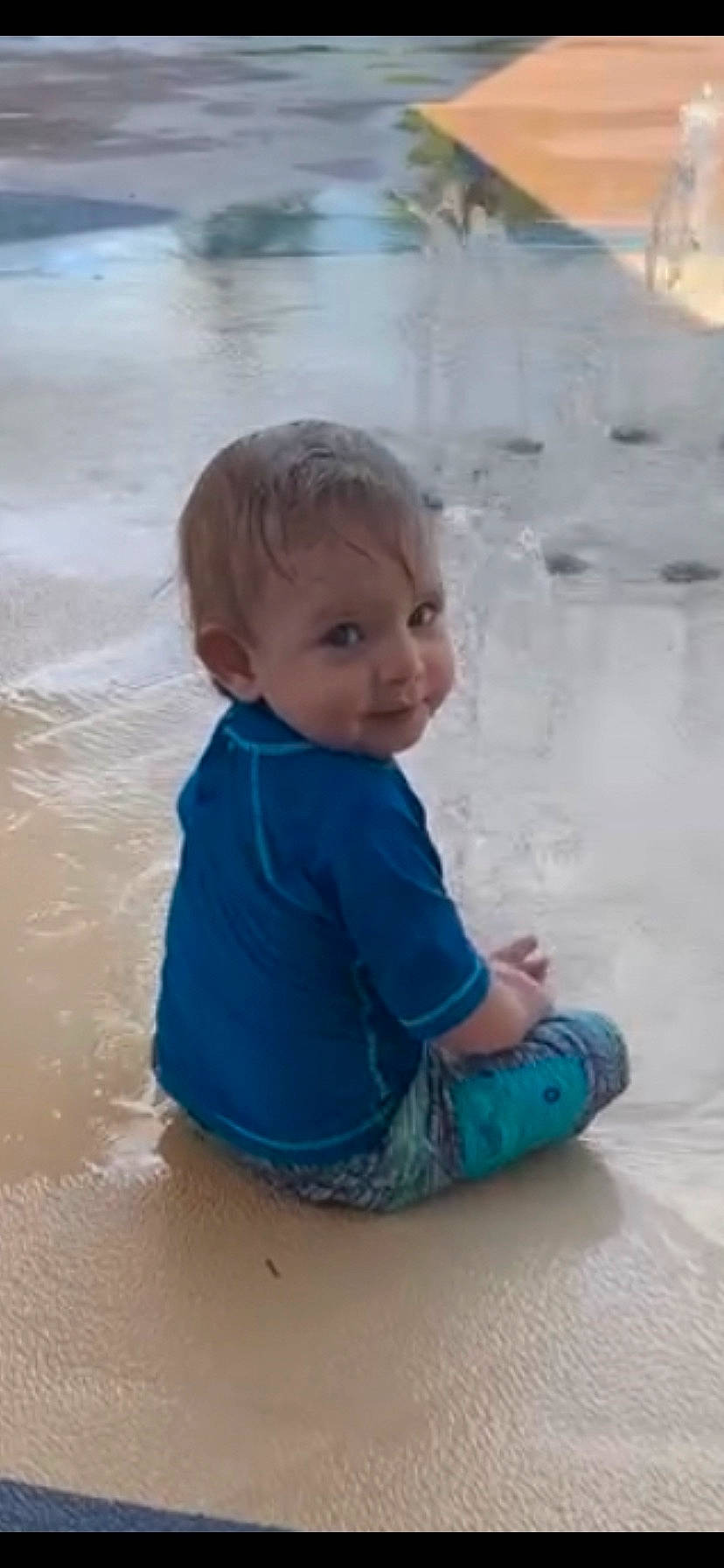 Kellan is registered to the contest to win money with this photo: azure, baby, baby_toddler_clothing, bathing, beach, child, fun, hairstyle, happy, ice_cap, leisure, person, recreation, sand, sitting, skin, standing, toddler, water, wave