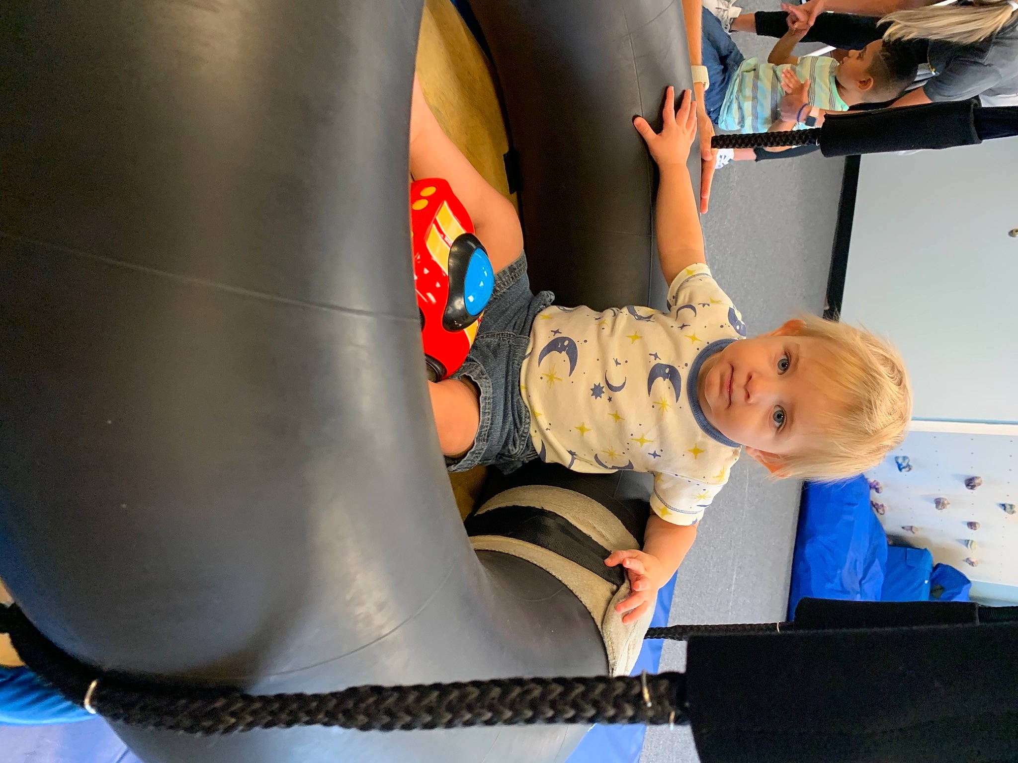 Kellan joined the competition — help win amazing prizes! baby, baby_products, child, comfort, electric_blue, fun, human_leg, inflatable, knee, leisure, outdoor_play_equipment, person, play, recreation, room, shelf, sitting, smile, t_shirt, toddler