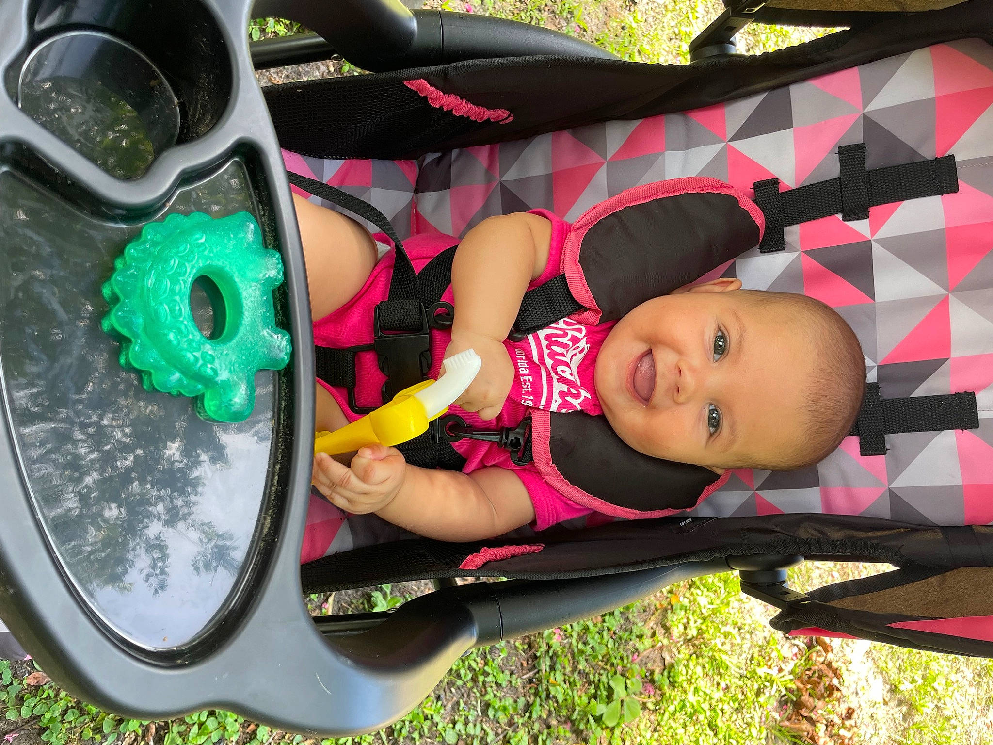 Sabrina is registered to the contest to win money with this photo: auto_part, automotive_design, automotive_exterior, automotive_tire, child, fender, fun, grass, green, hubcap, joy, leisure, person, pink, product, rim, shoe, smile, sneakers, tire