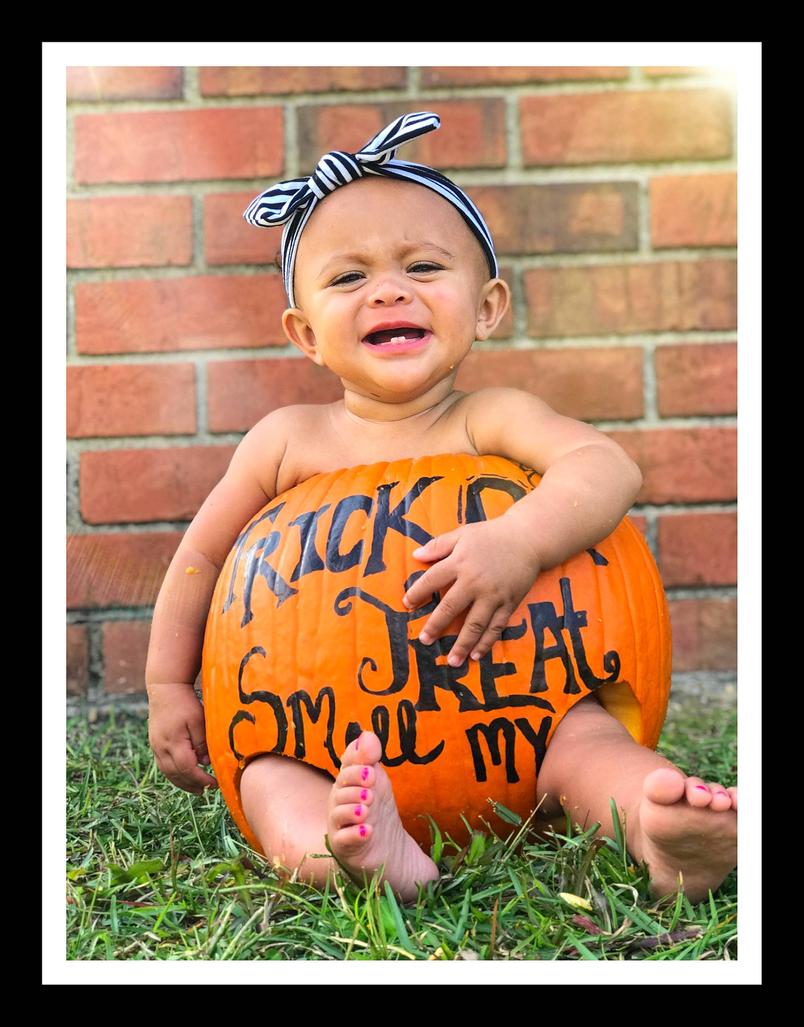 Kylance is registered to the contest to win money with this photo: baby, baby_toddler_clothing, calabaza, child, child_model, facial_expression, fun, happy, orange, person, photo_caption, photography, play, pumpkin, smile, sorrow, toddler