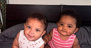 Zariyah N Saliyah is registered to the contest to win money with this photo: baby, infant, child, cute, bed, onesie, pink, white, striped_clothing, polka_dot_clothing, chubby, sitting, indoor, portrait, people, two_babies, smiling, curious, head, face