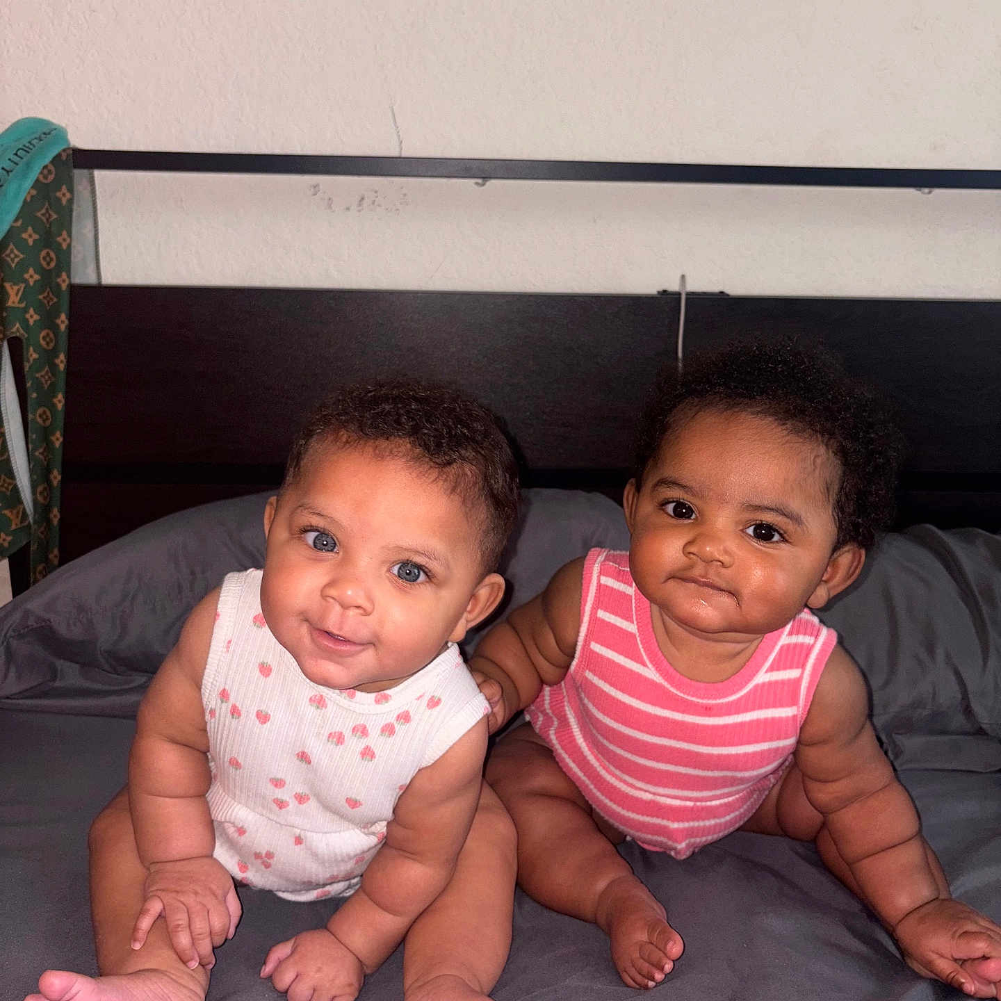 Zariyah N Saliyah is registered to the contest to win money with this photo: baby, infant, child, cute, bed, onesie, pink, white, striped_clothing, polka_dot_clothing, chubby, sitting, indoor, portrait, people, two_babies, smiling, curious, head, face