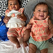 Zariyah N Saliyah is registered to the contest to win money with this photo: baby, infant, smiling, cute, leopard_print, pillow, bed, clothing, peach_pattern, happy, portrait, two_babies, lying_down, indoors, child, cute_outfit, sibling, joy, face, skin