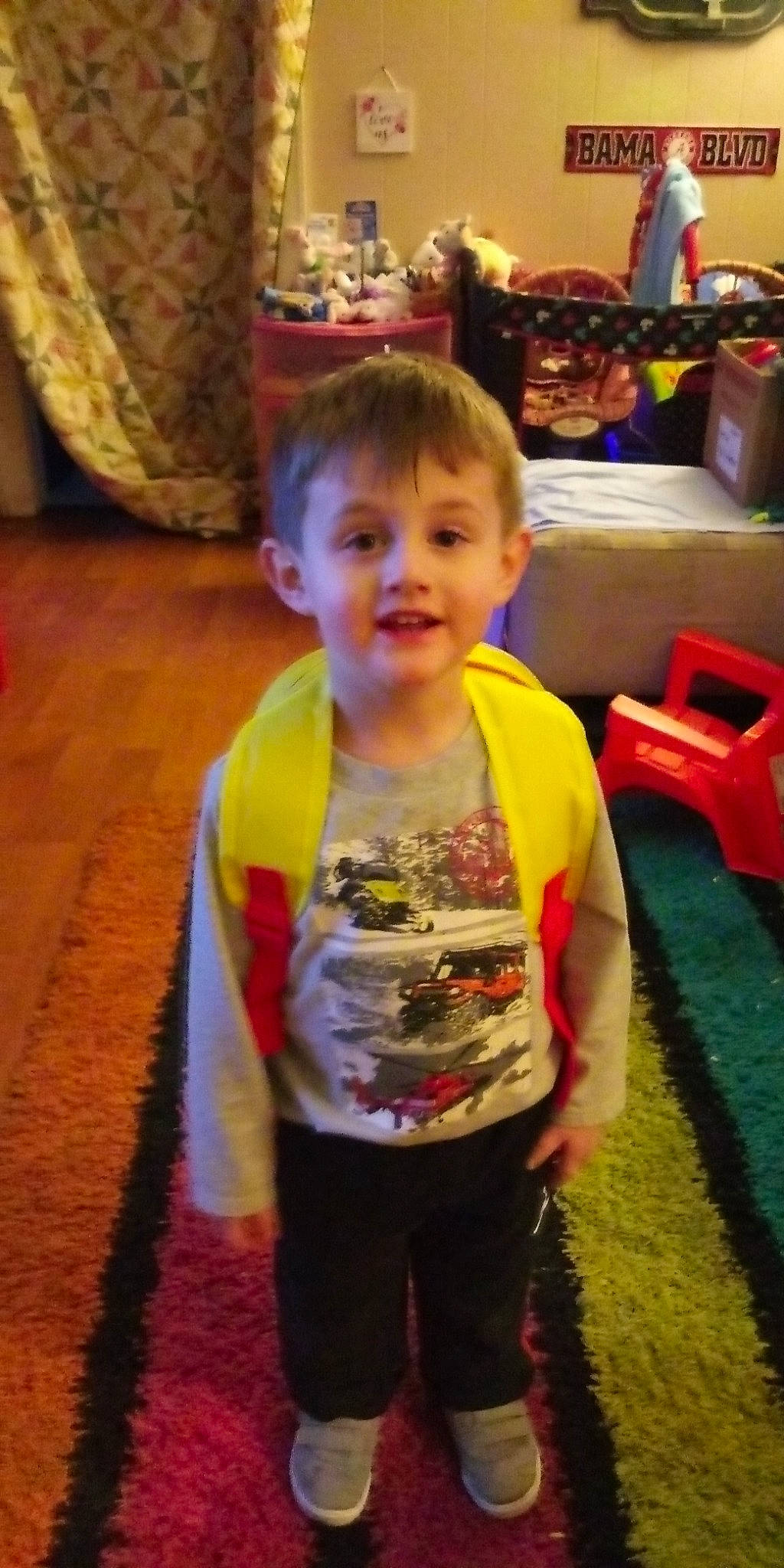 Gabe is registered to the contest to win money with this photo: arm, baby, cheek, child, ear, eye, flooring, fun, leg, person, play, room, sitting, smile, snapshot, standing, thumb, toddler