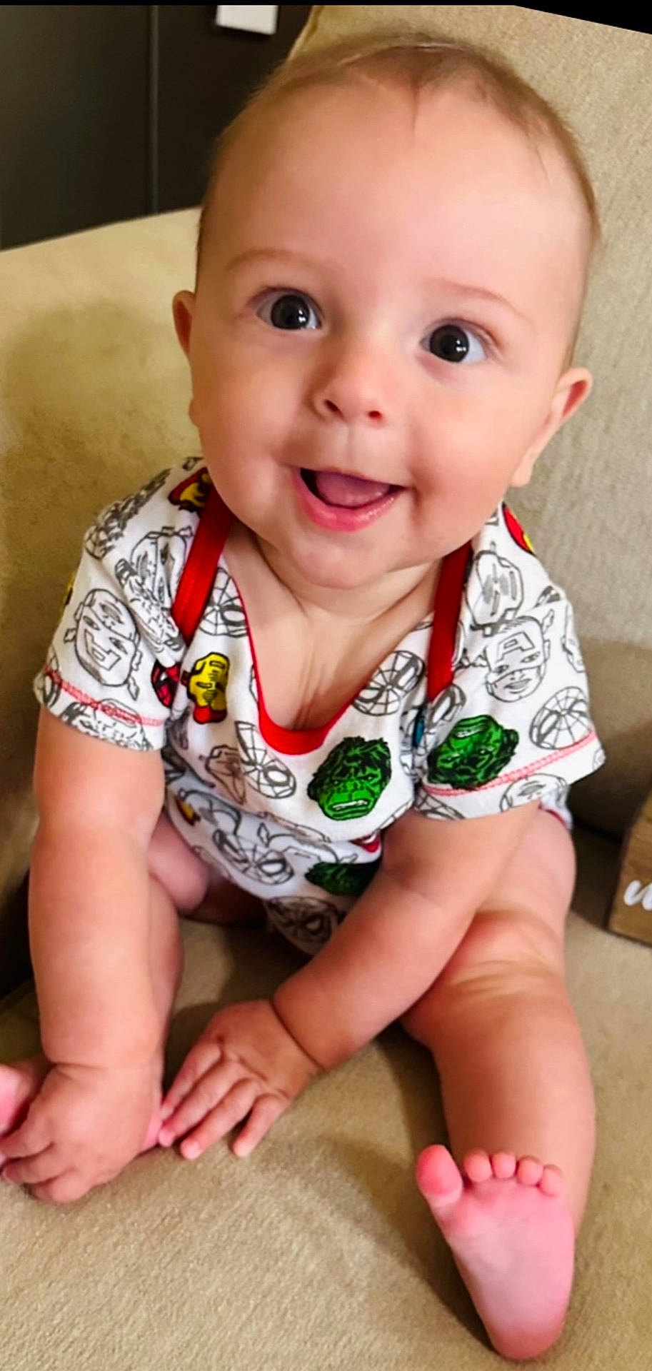 Ellis is registered to the contest to win money with this photo: accessories, baby, babylaughing, bodypart, clothing, face, finger, hand, happy, head, jewelry, laughing, necklace, person, photography, portrait, shorts, sitting, smile, t_shirt