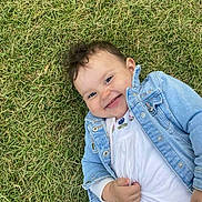 Ana-Maria a rejoint le concours — aidez-le/la à gagner de superbes lots ! baby, child, grass, smiling, denim_jacket, white_shirt, happy, outdoor, cute, young_child, portrait, nature, playful, person, casual_clothing, face, head, skin, baby_girl, lying_down