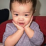 Kelly joined the competition — help win amazing prizes! toddler, child, face, hands, purple_clothing, couch, red_couch, sitting, indoor, cute, smiling, portrait, baby, young_child, expression, cozy, home, person, skin, hair