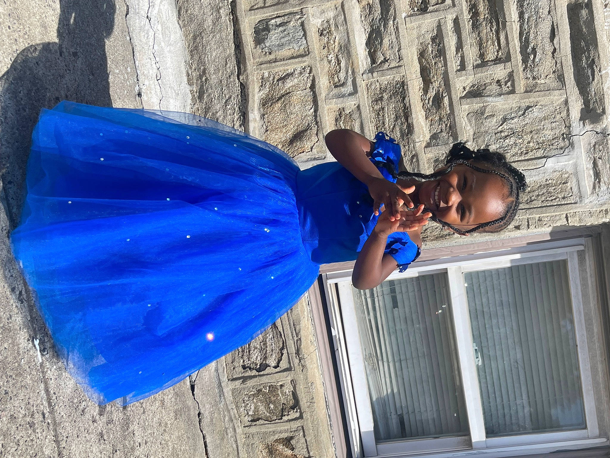 Kennedy is registered to the contest to win money with this photo: blue, denim, dress, electric_blue, formal_wear, fun, hat, human_leg, joy, leisure, person, purple, street, sunglasses, t_shirt, waist, wall, water, wood