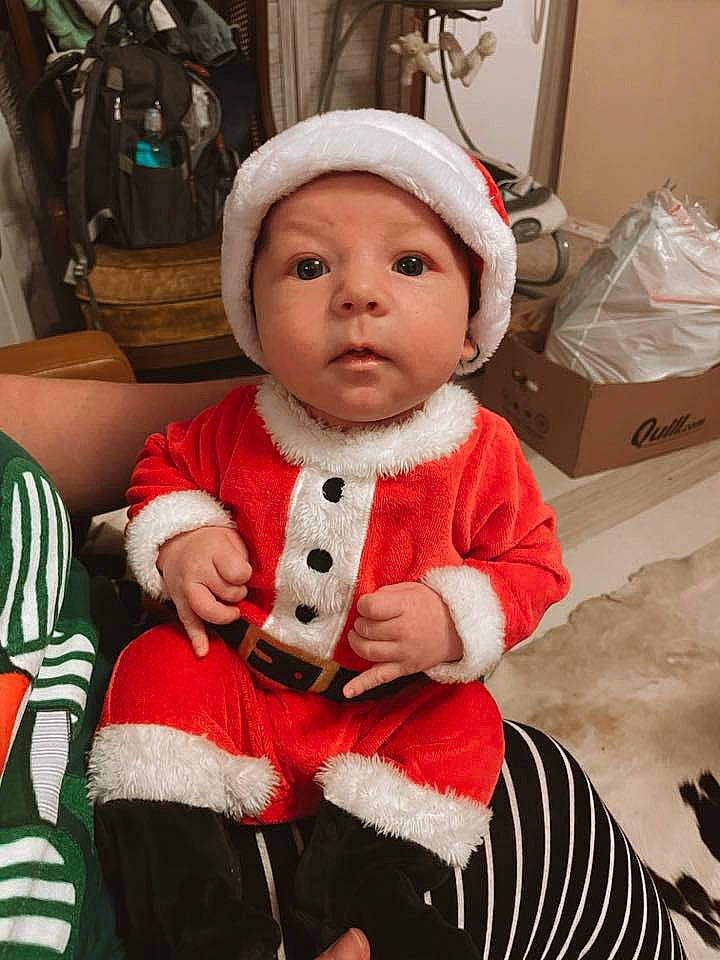 Myles joined the competition — help win amazing prizes! baby, baby_toddler_clothing, box, carmine, cheek, child, christmas, christmas_eve, event, fur, head, headgear, headwear, holiday, pattern, person, shipping_box, sitting, sleeve, toddler