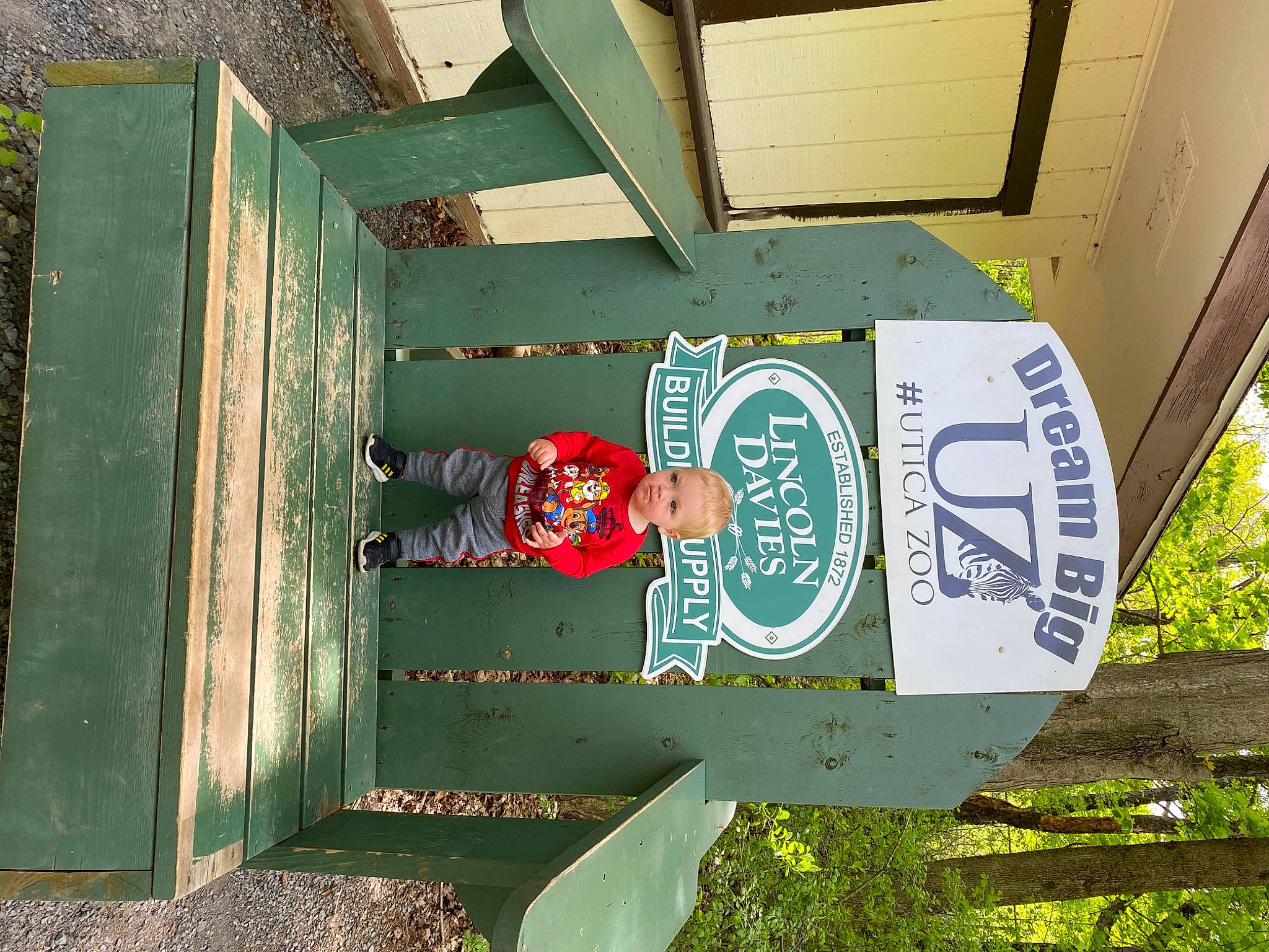 Haiden is registered to the contest to win money with this photo: advertising, art, font, grass, hat, landscape, leisure, logo, machine, person, plant, rectangle, sign, signage, soil, tints_and_shades, tree, visual_arts, wood, world