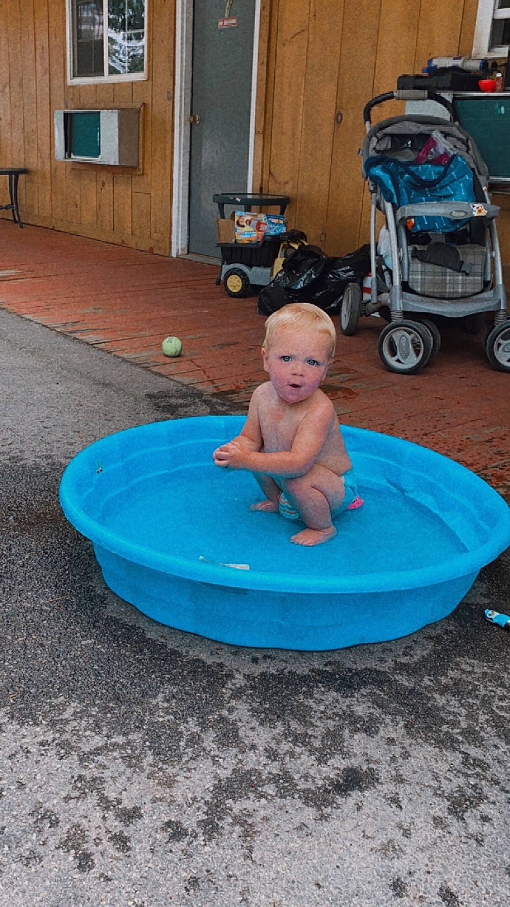 Haiden joined the competition — help win amazing prizes! barefoot, child, door, electric_blue, flooring, fun, human_leg, leg, leisure, person, pink, public_space, recreation, road_surface, sitting, smile, tire, toddler, vacation, wheel