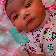 Elaini is registered to the contest to win money with this photo: baby, infant, headband, pink_bow, pacifier, hello_kitty, blanket, soft_texture, cute, child, clothing, lying_down, face, portrait, indoors, sleepwear, adorable, newborn, resting, toddler