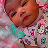 baby, infant, headband, pink_bow, pacifier, hello_kitty, blanket, soft_texture, cute, child, clothing, lying_down, face, portrait, indoors, sleepwear, adorable, newborn, resting, toddler