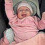 baby, infant, pink_clothing, knit_hat, mittens, blanket, stroller, smiling, happy, cute, child, face, cozy, warm, portrait, sitting, person, baby_girl, raised_arm, indoors