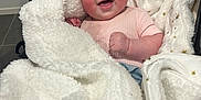 Ariya is registered to the contest to win money with this photo: baby, smiling, blanket, white, golden_stars, clothing, infant, happy, face, cute, person, indoor, cozy, soft_texture, newborn, wrapped, child, comfort, warm, portrait
