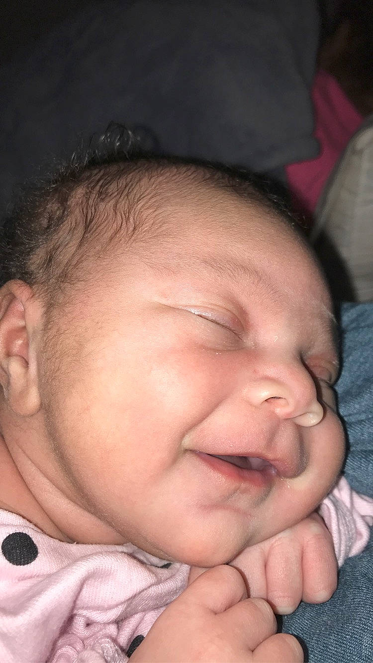 Emerald is registered to the contest to win money with this photo: baby, bedtime, cheek, child, chin, close_up, ear, face, facial_expression, forehead, gesture, hand, head, lip, mouth, nose, person, skin, sleep, smile