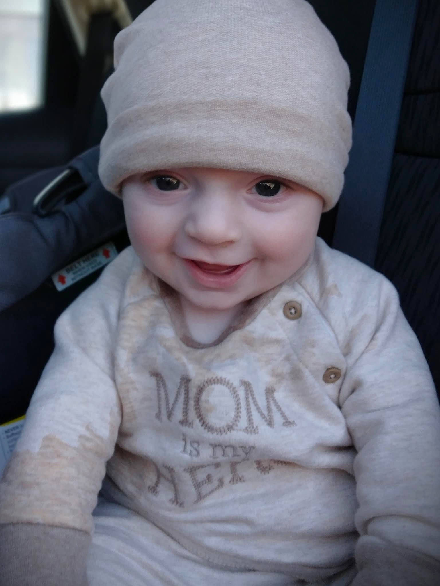 Jaxon joined the competition — help win amazing prizes! baby, baby_toddler_clothing, beanie, cap, cheek, child, fashion_accessory, happy, headwear, knit_cap, lip, person, portrait_photography, sitting, skin, sleeve, smile, steering_wheel, toddler, winter