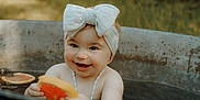 Elya participe au concours pour gagner de l'argent avec cette photo : baby, child, headband, bow, water, tub, citrus, orange_slice, grapefruit_slice, smiling, happy, outdoor, nature, skin, necklace, playful, summer, cute, infant, portrait
