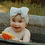 baby, child, headband, bow, water, tub, citrus, orange_slice, grapefruit_slice, smiling, happy, outdoor, nature, skin, necklace, playful, summer, cute, infant, portrait