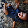 Eric joined the competition — help win amazing prizes! baby, child, infant, smiling, happy, lying_down, rug, carpet, indoor, portrait, face, open_mouth, kicking, legs, striped_clothing, blue_shirt, bare_feet, adult_feet, home, photography