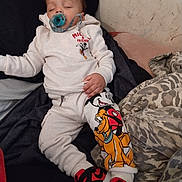 Eric joined the competition — help win amazing prizes! baby, sleeping, pacifier, bed, blanket, pillow, indoors, portrait, child, infant, clothing, hoodie, sweatpants, cartoon, mickey_mouse, pluto, shoes, black_pillow, cozy, nap