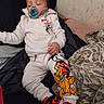 baby, sleeping, pacifier, bed, blanket, pillow, indoors, portrait, child, infant, clothing, hoodie, sweatpants, cartoon, mickey_mouse, pluto, shoes, black_pillow, cozy, nap