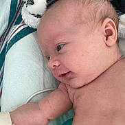 Harper is registered to the contest to win money with this photo: arm, baby, blanket, body, child, closeup, cozy, curious, ear, face, head, hospital, hospital_wristband, infant, laying_down, newborn, person, skin, soft_fabric, striped