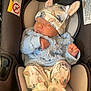baby, newborn, sleeping, car_seat, hat, bunny_ears, blue_sweater, cozy, infant, cute, child, soft_lighting, peaceful, small_hands, clothing, indoors, resting, car_seat_padding, adorable, quiet