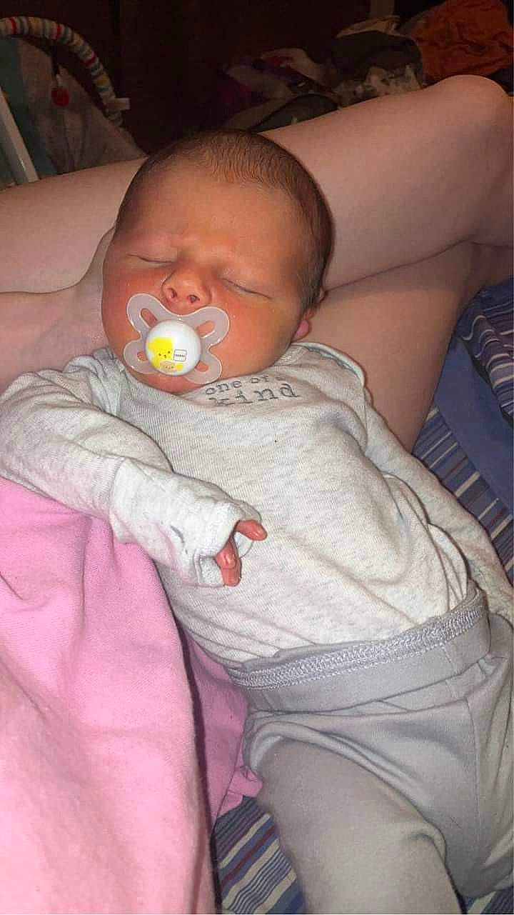 Legacy is registered to the contest to win money with this photo: baby, baby_products, baby_toddler_clothing, cheek, child, comfort, finger, human_leg, iris, lap, lip, mouth, nail, nose, person, sitting, skin, sleeve, thigh, thumb