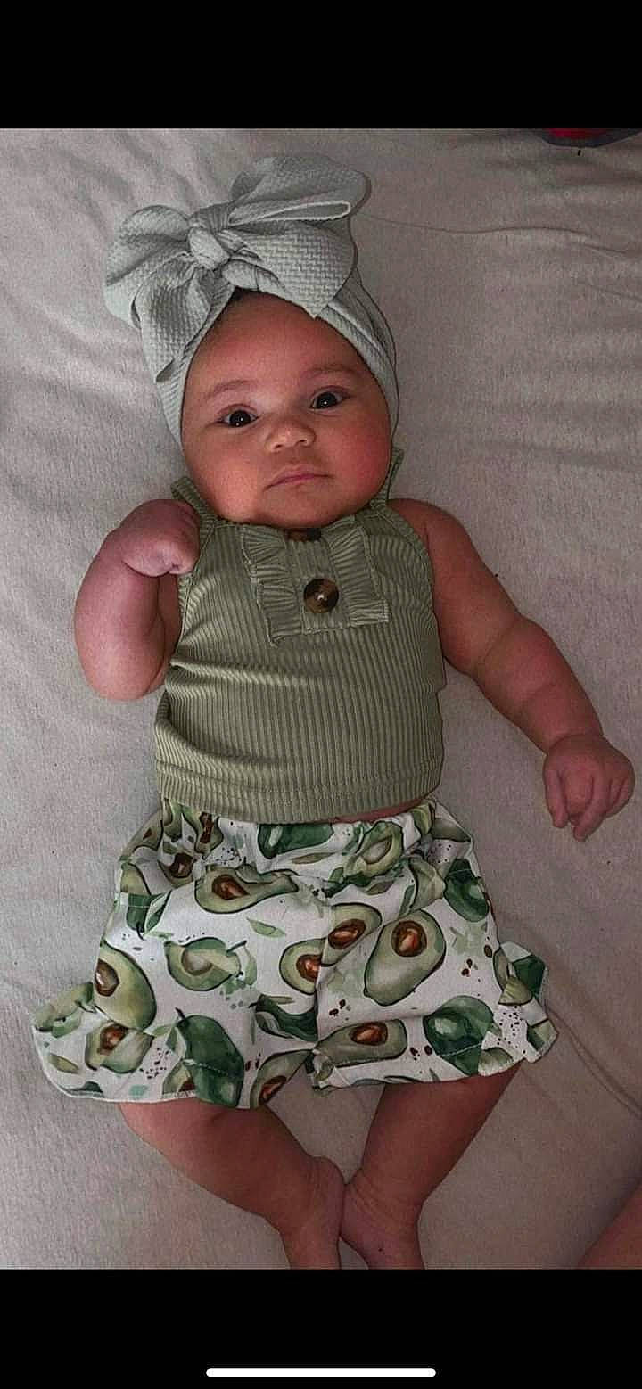 Samaya joined the competition — help win amazing prizes! baby, baby_products, baby_toddler_clothing, cap, child, day_dress, dress, face, finger, headwear, human_body, linens, one_piece_garment, outerwear, pattern, person, pink, skin, sleeve, t_shirt