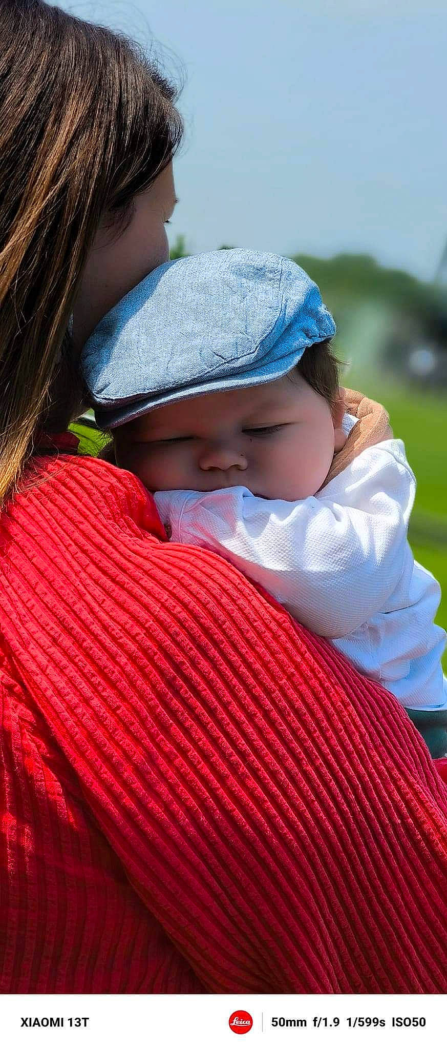 Juliann participe au concours pour gagner de l'argent avec cette photo : baby, baby_products, baby_toddler_clothing, cap, child, comfort, grass, happy, hat, headwear, hug, leisure, lip, magenta, people_in_nature, person, pink, sitting, skin, sky