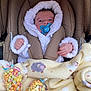 baby, blanket, car_seat, child, clothing, colorful, cozy, cute, face, hand, hoodie, infant, pacifier, popcorn, seated, sheep_pattern, snug, soft, warm, wrapped