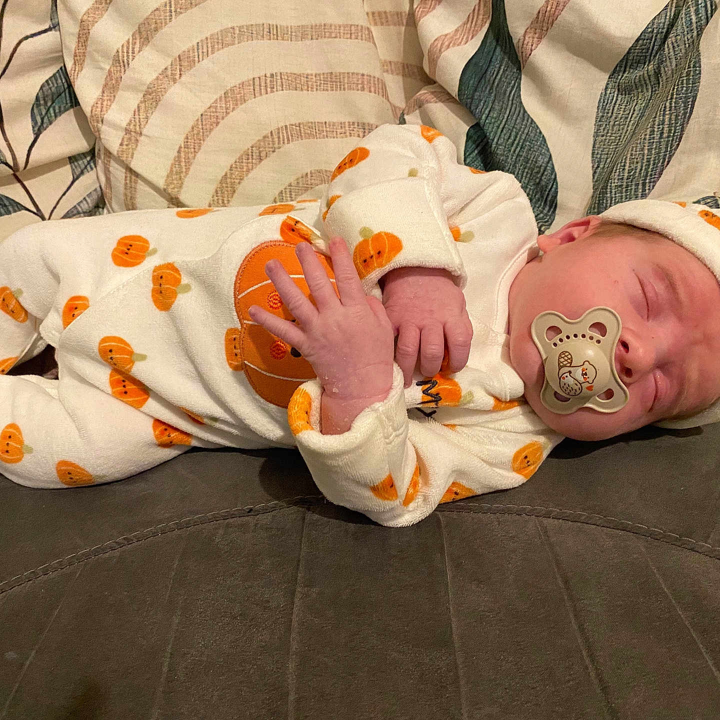 Darwin-James joined the competition — help win amazing prizes! baby, child, clothing, couch, cozy, cushions, cute, fabric, hat, indoors, infant, newborn, onesie, pacifier, peaceful, portrait, pumpkin_pattern, resting, sleeping, soft