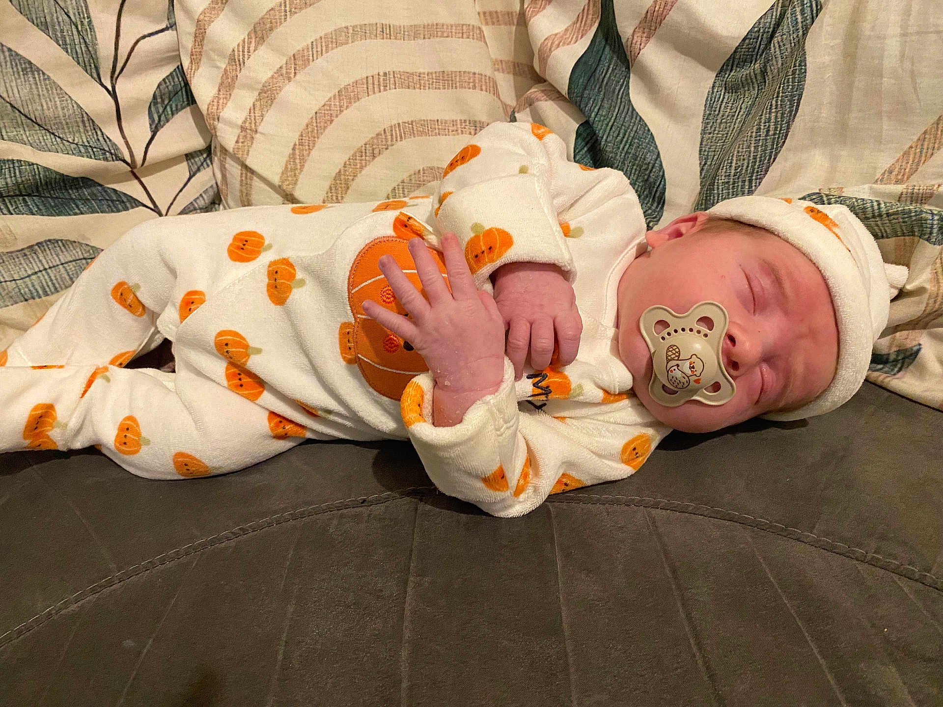 Darwin-James joined the competition — help win amazing prizes! baby, child, clothing, couch, cozy, cushions, cute, fabric, hat, indoors, infant, newborn, onesie, pacifier, peaceful, portrait, pumpkin_pattern, resting, sleeping, soft
