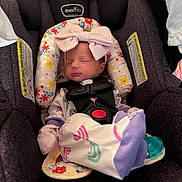 Kaylene joined the competition — help win amazing prizes! baby, newborn, infant, car_seat, headband, bow, sleeping, harness, buckle, floral_pattern, pajamas, mittens, pacifier, cozy, portrait, indoors, fabric, soft_toys_accessory, cute, seat_padding