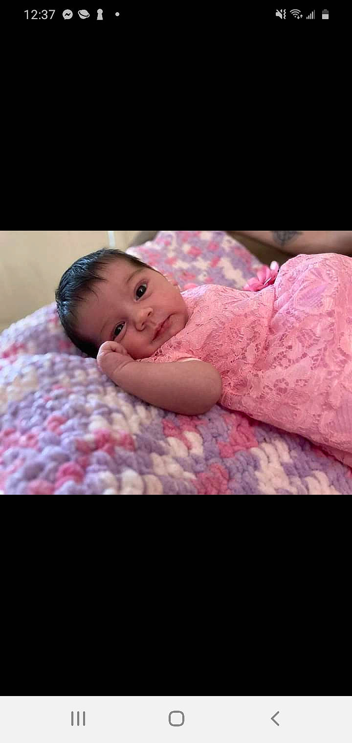 Natalie is registered to the contest to win money with this photo: arm, baby, baby_toddler_clothing, cheek, comfort, eye, face, flash_photography, hand, happy, headgear, human_body, iris, linens, lip, magenta, person, pink, skin, sleeve