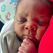 Kyzan is registered to the contest to win money with this photo: baby, sleeping, closeup, face, hand, infant, skin, blanket, cushion, red, peaceful, resting, newborn, soft, cute, portrait, indoors, child, wrapped, relaxing